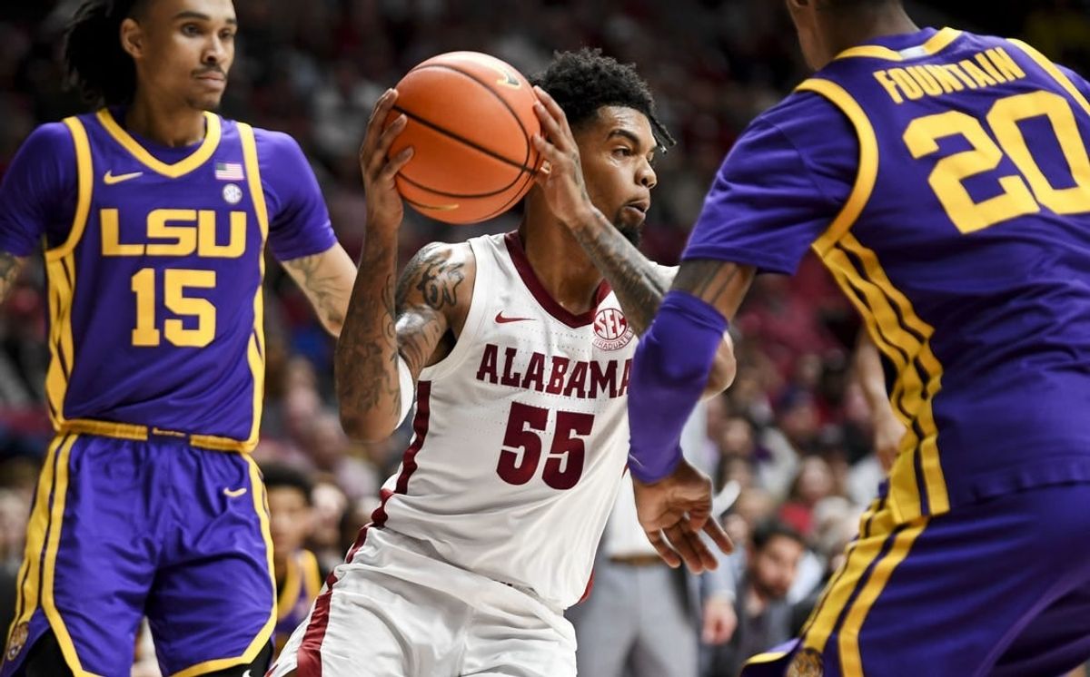 Jan 27, 2024; Tuscaloosa, Alabama, USA;  Alabama guard Aaron Estrada cuts between LSU forward Tyrell Ward (15) and LSU forward Derek Fountain (20) at Coleman Coliseum.