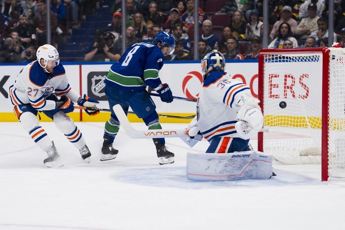 Oct 11, 2023; Vancouver, British Columbia, CAN; Edmonton Oilers defenseman Brett Kulak (27) watches as Vancouver Canucks forward Conor Garland (8) scores on goalie Jack Campbell (36) in the first period at Rogers Arena.