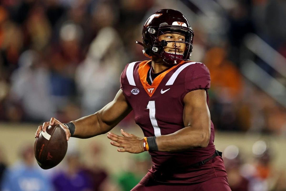 Nov 18, 2023; Blacksburg, Virginia, USA; Virginia Tech Hokies quarterback Kyron Drones (1) throws a pass during the fourth quarter against the North Carolina State Wolfpack at Lane Stadium.