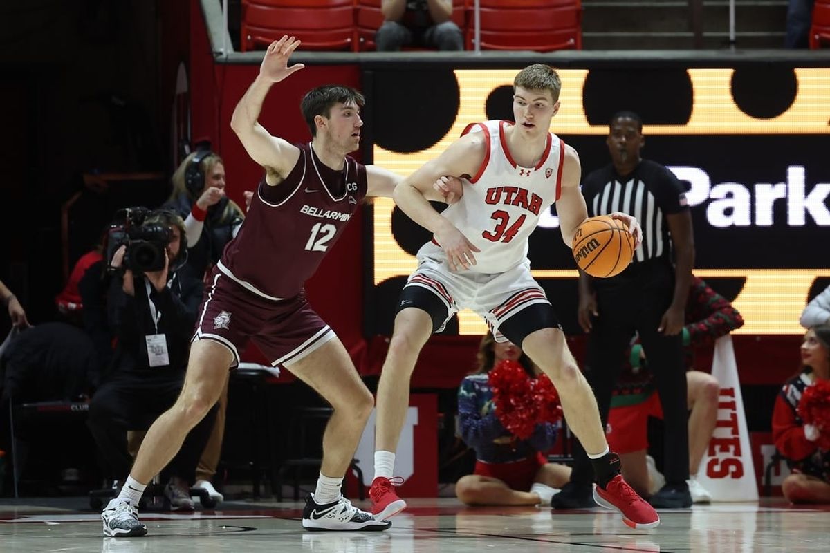 Dec 20, 2023; Salt Lake City, Utah, USA; Utah Utes center Lawson Lovering (34) posts up against Bellarmine Knights forward Langdon Hatton (12) during the first half at Jon M. Huntsman Center.