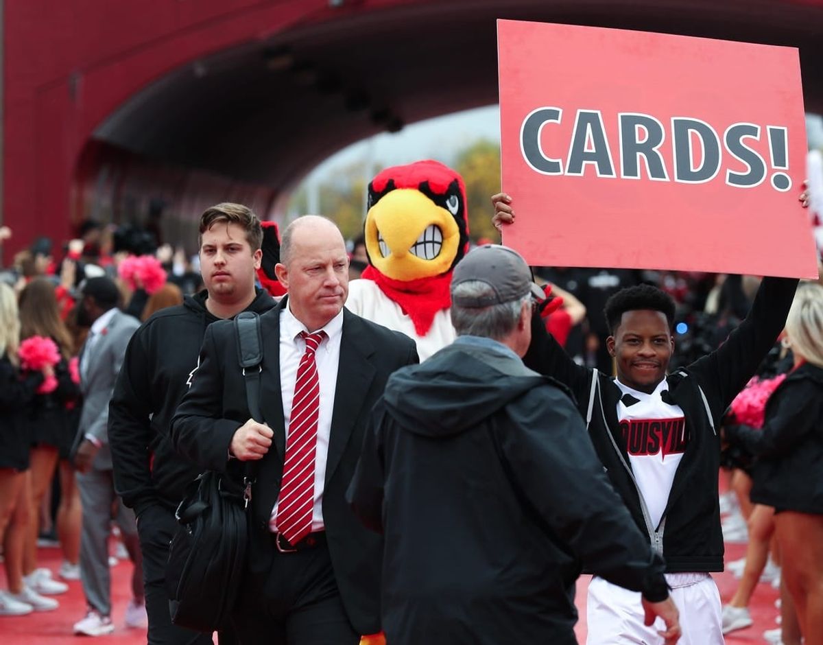 U of L head football coach Jeff Brohm enters the stadium during the Cards March ahead of their game against Duke at the L&N Stadium in Louisville, Ky. on Oct. 28, 2023.