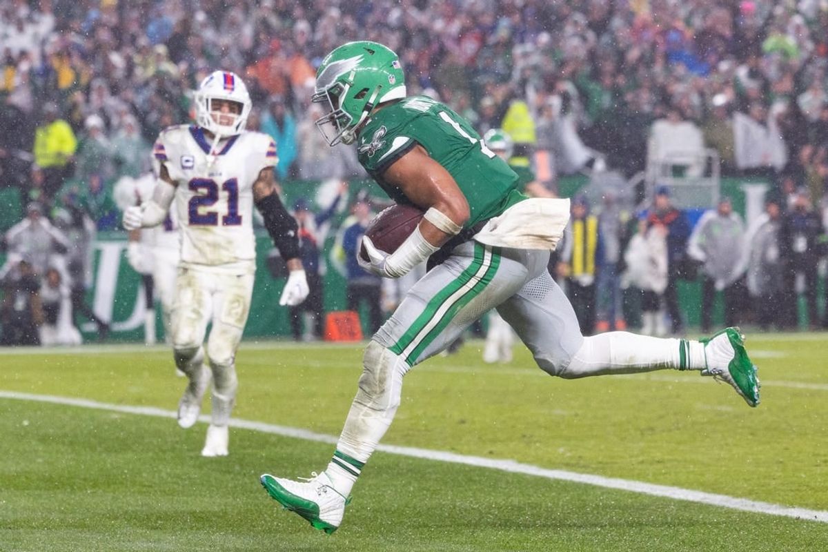 Nov 26, 2023; Philadelphia, Pennsylvania, USA; Philadelphia Eagles quarterback Jalen Hurts (1) scores the game winning touchdown in front of Buffalo Bills safety Jordan Poyer (21) in overtime at Lincoln Financial Field.