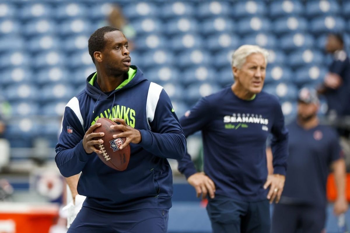 Seattle Seahawks quarterback Geno Smith and head coach Pete Carroll (background) can crash the playoffs with a win and some help from the Chicago Bears.