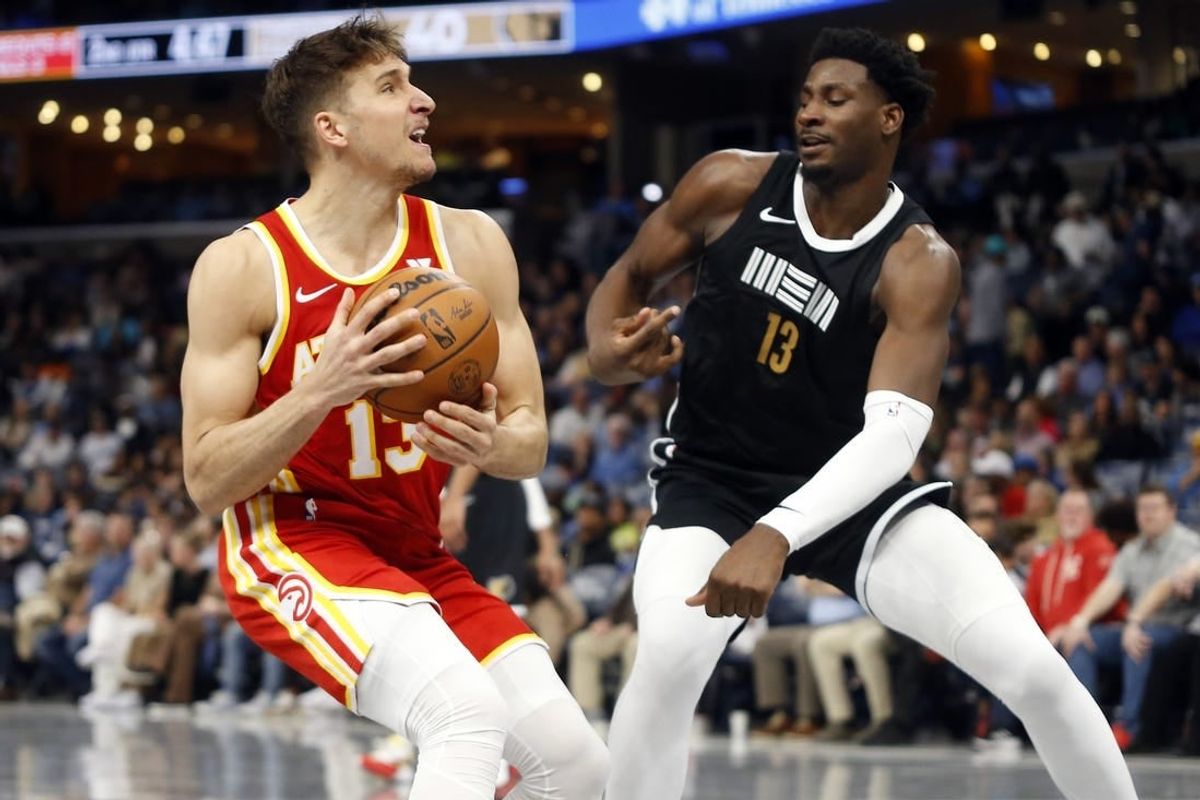 Mar 8, 2024; Memphis, Tennessee, USA; Atlanta Hawks guard Bogdan Bogdanovic (13) drives to the basket as Memphis Grizzlies forward-center Jaren Jackson Jr. (13) defends during the first half at FedExForum.