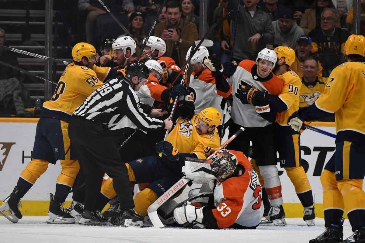 Dec 12, 2023; Nashville, Tennessee, USA; Nashville Predators and Philadelphia Flyers players have to be separated after a save by Philadelphia Flyers goaltender Samuel Ersson (33) during the second period at Bridgestone Arena.