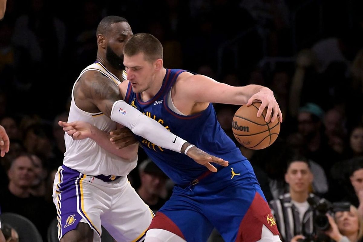 Mar 2, 2024; Los Angeles, California, USA;  Los Angeles Lakers forward LeBron James (23) guards Denver Nuggets center Nikola Jokic (15) in the second half at Crypto.com Arena.