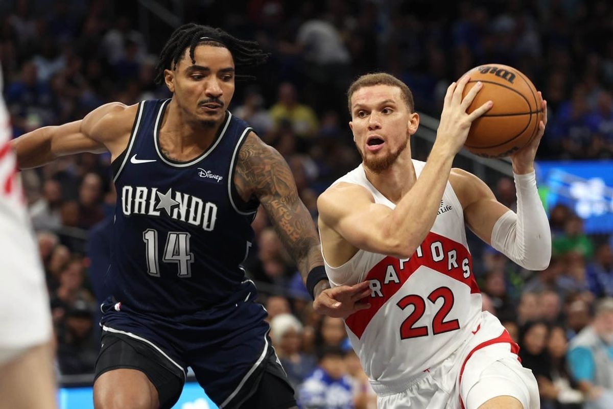 Nov 21, 2023; Orlando, Florida, USA;Toronto Raptors guard Malachi Flynn (22) drives to the basket as Orlando Magic guard Gary Harris (14) defends  during the second half at Amway Center.