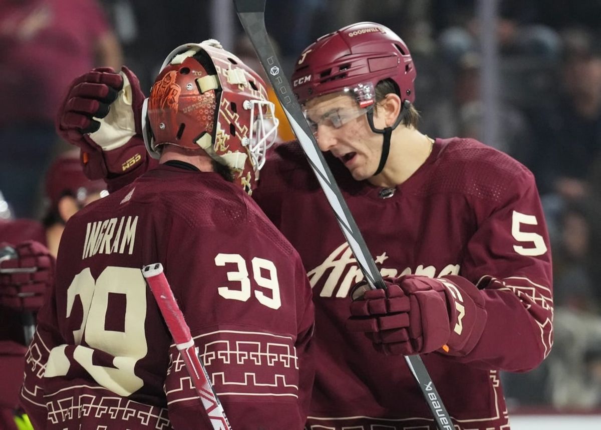 Jan 20, 2024; Tempe, Arizona, USA; Arizona Coyotes goaltender Connor Ingram (39) and Arizona Coyotes defenseman Michael Kesselring (5) celebrate after defeating the Nashville Predators during at Mullett Arena.