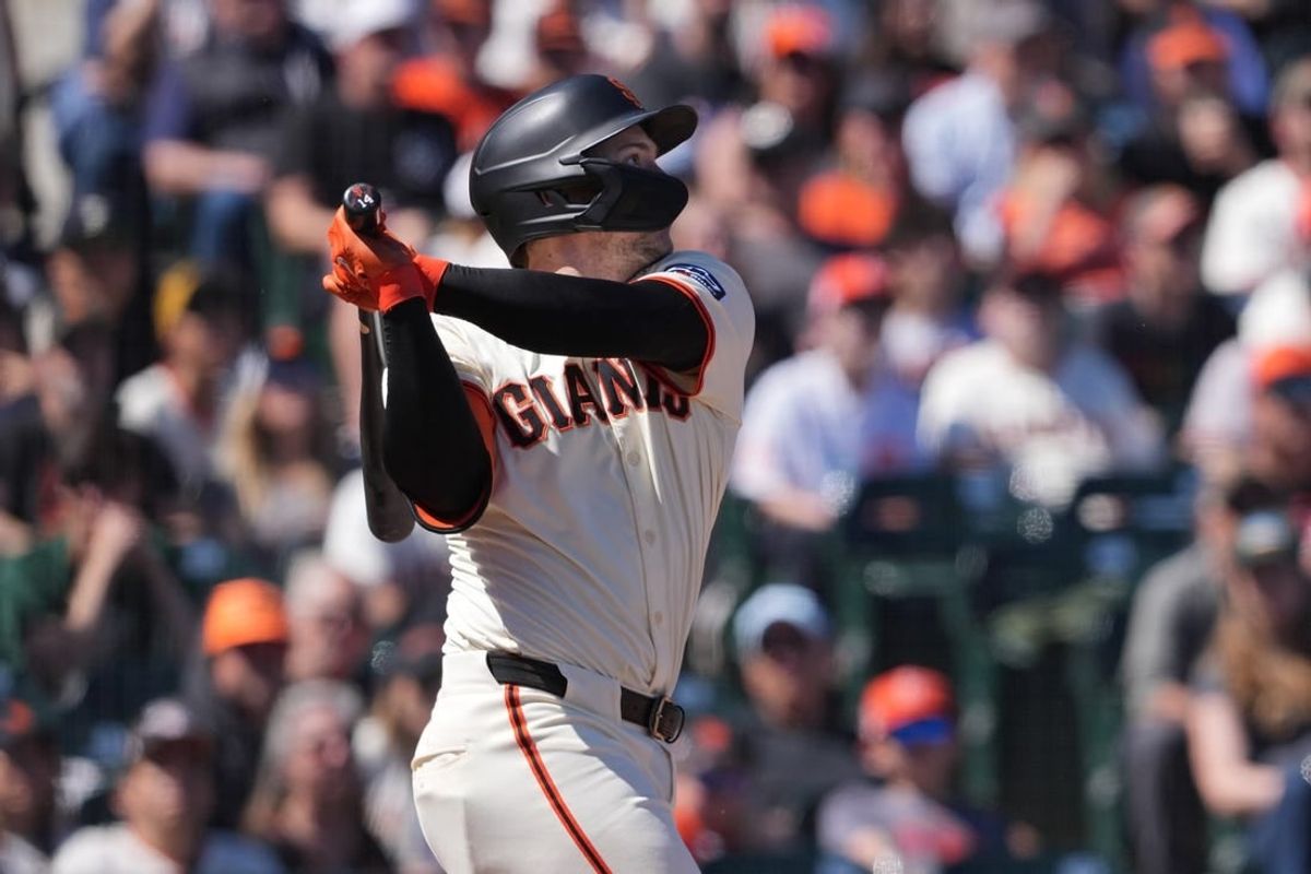 Apr 20, 2024; San Francisco, California, USA; San Francisco Giants catcher Patrick Bailey (14) hits a double against the Arizona Diamondbacks during the seventh inning at Oracle Park.