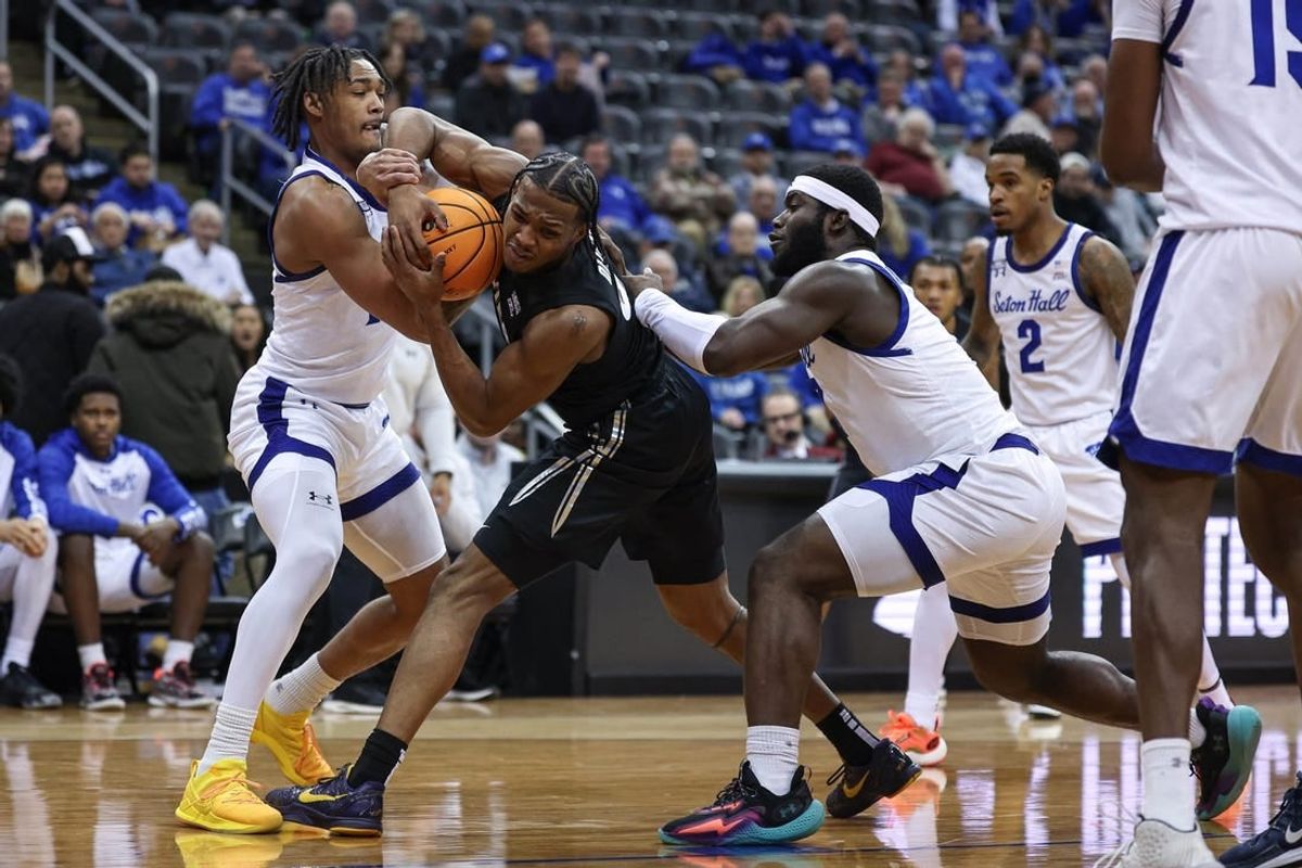 Feb 14, 2024; Newark, New Jersey, USA; Xavier Musketeers guard Quincy Olivari (8) is tied up by Seton Hall Pirates guard Dre Davis (14) and guard Dylan Addae-Wusu (0) during the first half at Prudential Center.