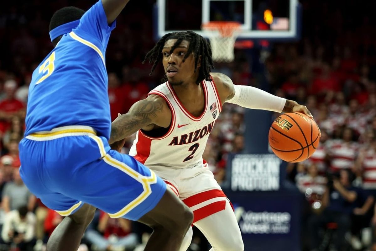 Jan 20, 2024; Tucson, Arizona, USA; Arizona Wildcats guard Caleb Love (2) dribbles the ball agaisnt UCLA Bruins forward Adem Bona (3) during the second half at McKale Center.