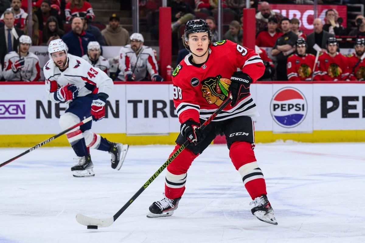 Dec 10, 2023; Chicago, Illinois, USA; Chicago Blackhawks center Connor Bedard (98) passes the puck against the Washington Capitals during the first period at the United Center.