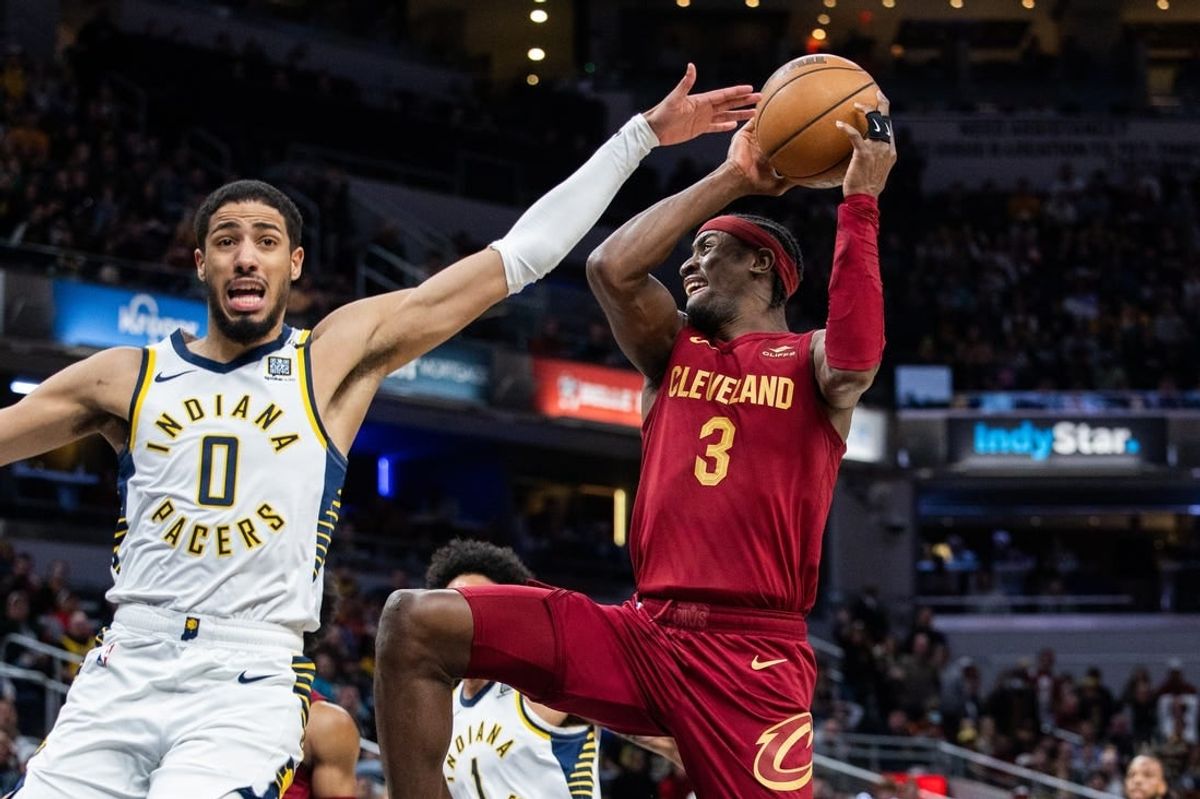 Mar 18, 2024; Indianapolis, Indiana, USA; Cleveland Cavaliers guard Caris LeVert (3) shoots the ball while Indiana Pacers guard Tyrese Haliburton (0) defends in the second half at Gainbridge Fieldhouse.