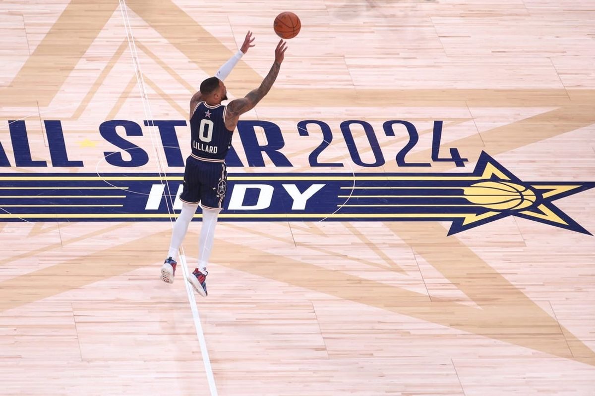 Feb 18, 2024; Indianapolis, Indiana, USA; Eastern Conference guard Damian Lillard (0) of the Milwaukee Bucks makes a three point basket from half court against the Western Conference All-Stars during the fourth quarter in the 73rd NBA All Star game at Gainbridge Fieldhouse.