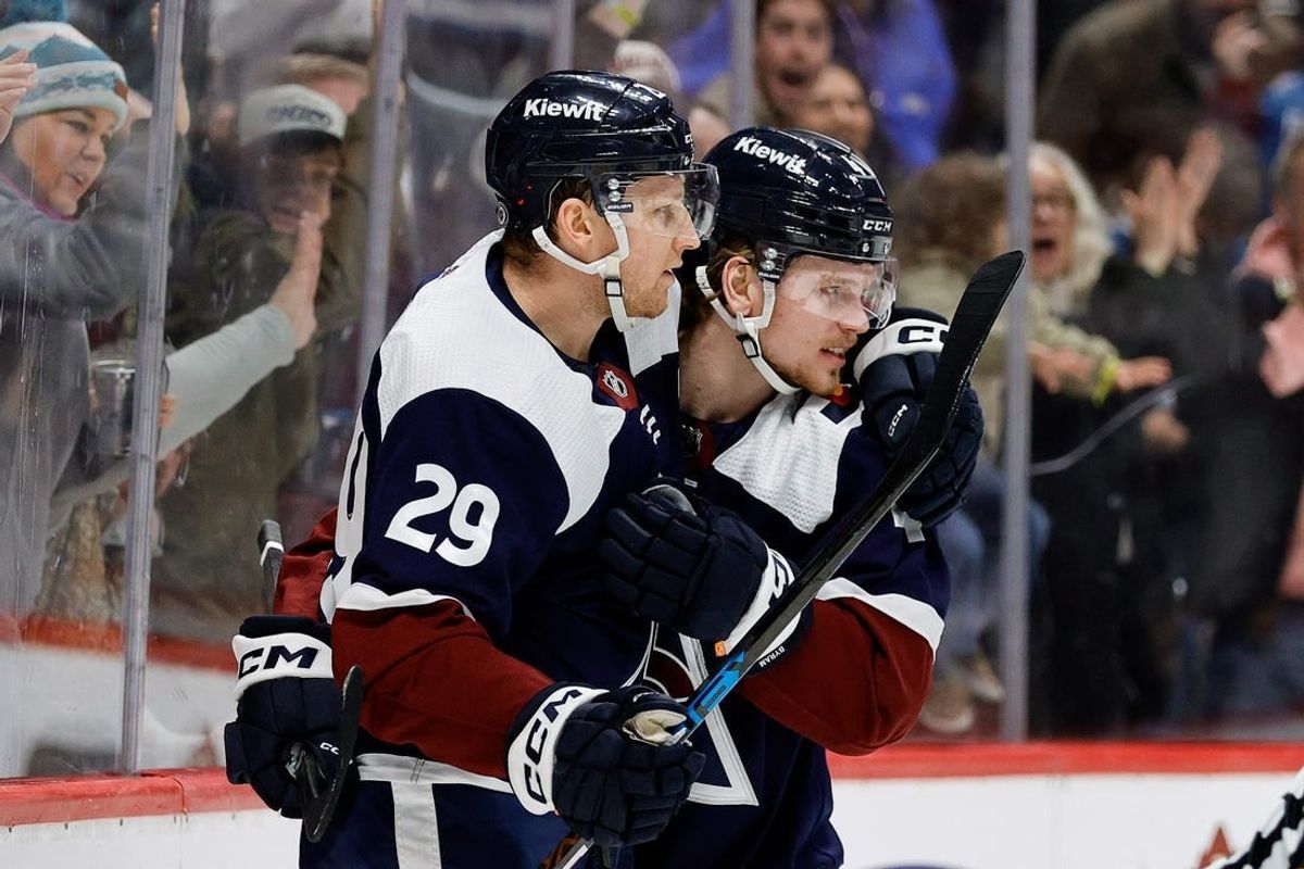 Feb 18, 2024; Denver, Colorado, USA; Colorado Avalanche center Nathan MacKinnon (29) celebrates his goal with defenseman Bowen Byram (4) in the second period against the Arizona Coyotes at Ball Arena.
