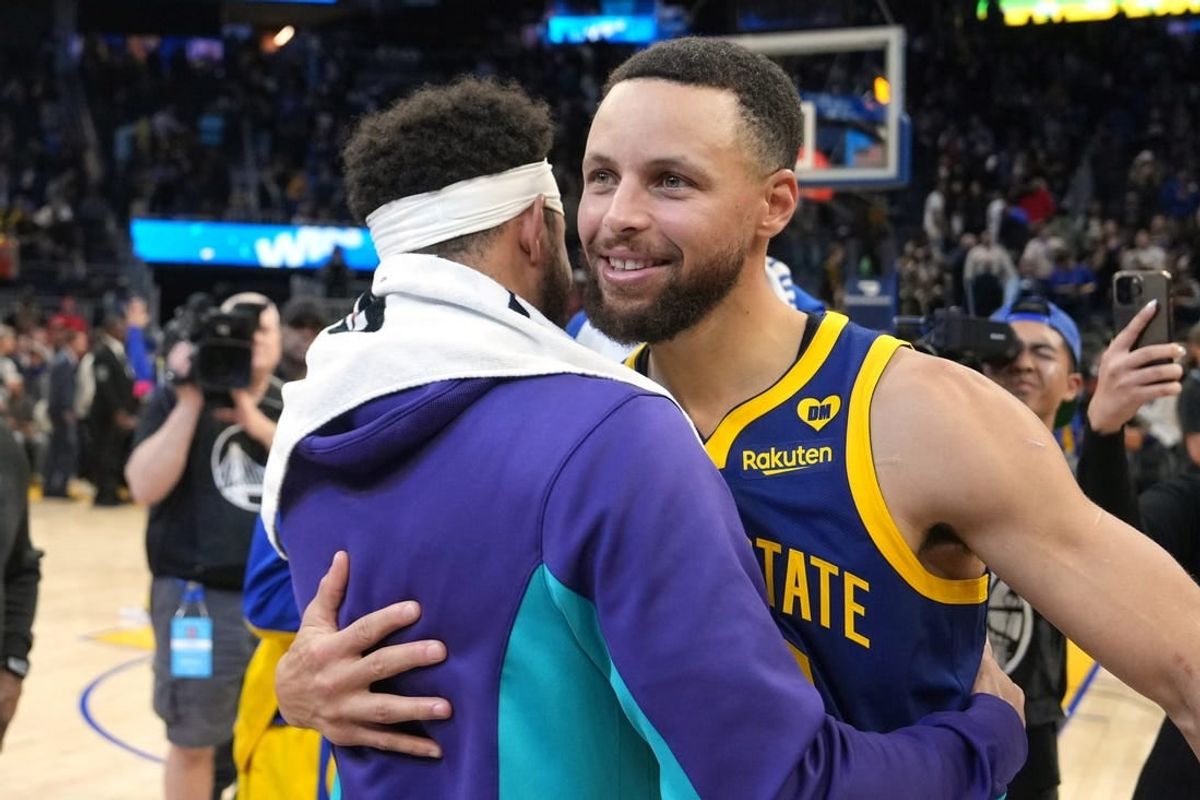 Feb 23, 2024; San Francisco, California, USA; Golden State Warriors guard Stephen Curry (right) hugs Charlotte Hornets guard Seth Curry (left) after the game at Chase Center.