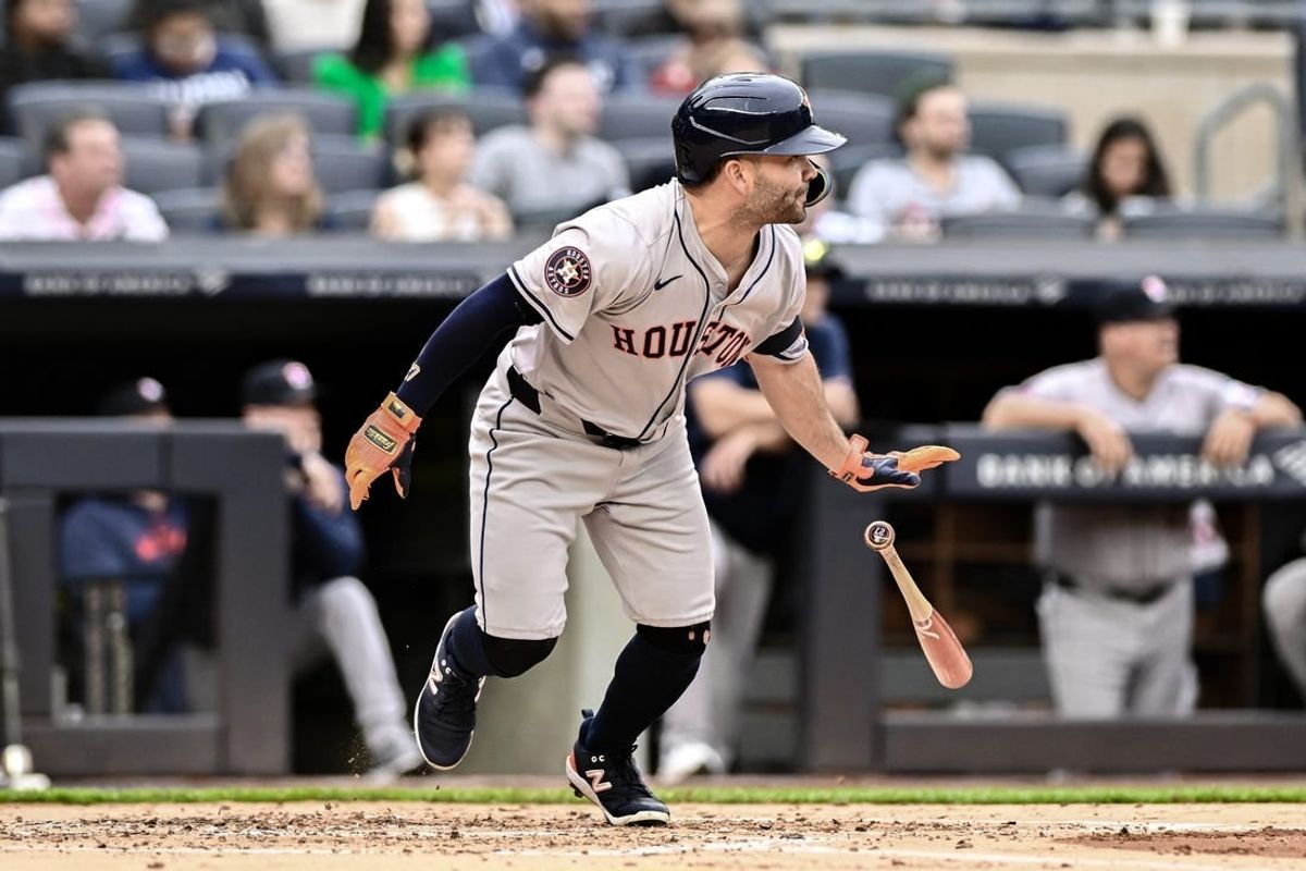 May 9, 2024; Bronx, New York, USA; Houston Astros second baseman Jose Altuve (27) hits a single against the New York Yankees during the second inning at Yankee Stadium.