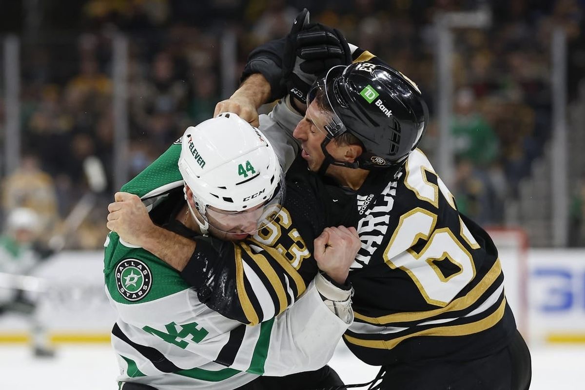 Feb 19, 2024; Boston, Massachusetts, USA; Dallas Stars defenseman Joel Hanley (44) fights with Boston Bruins left wing Brad Marchand (63) during the first period at TD Garden.