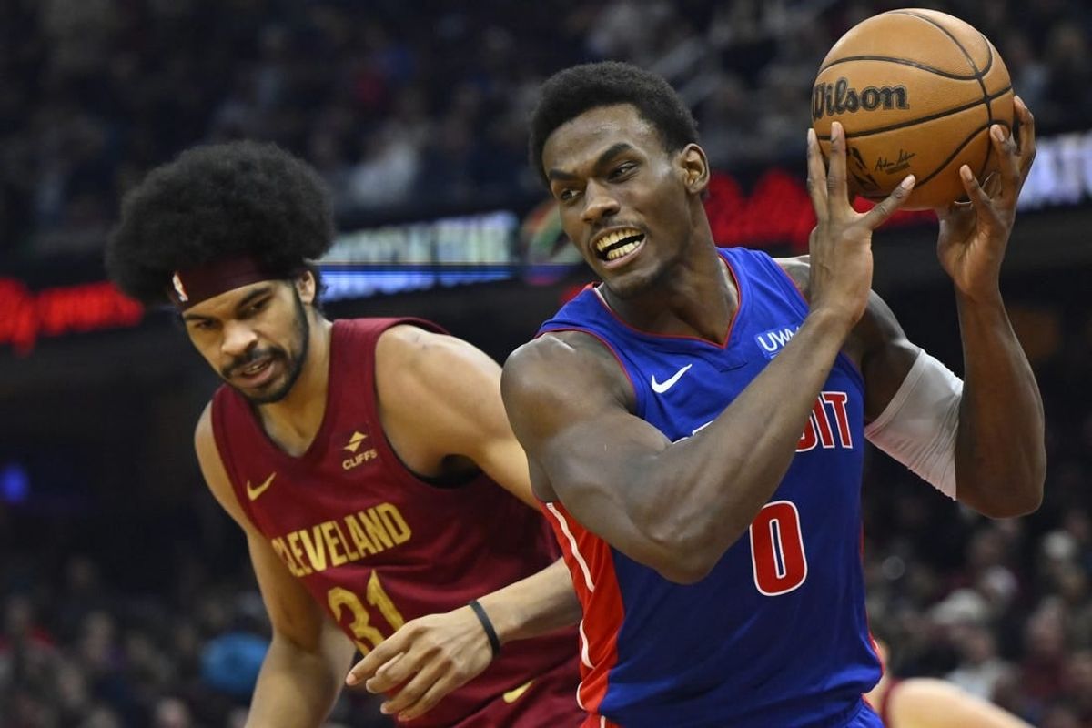 Jan 31, 2024; Cleveland, Ohio, USA; Detroit Pistons center Jalen Duren (0) controls the ball beside Cleveland Cavaliers center Jarrett Allen (31) in the second quarter at Rocket Mortgage FieldHouse.