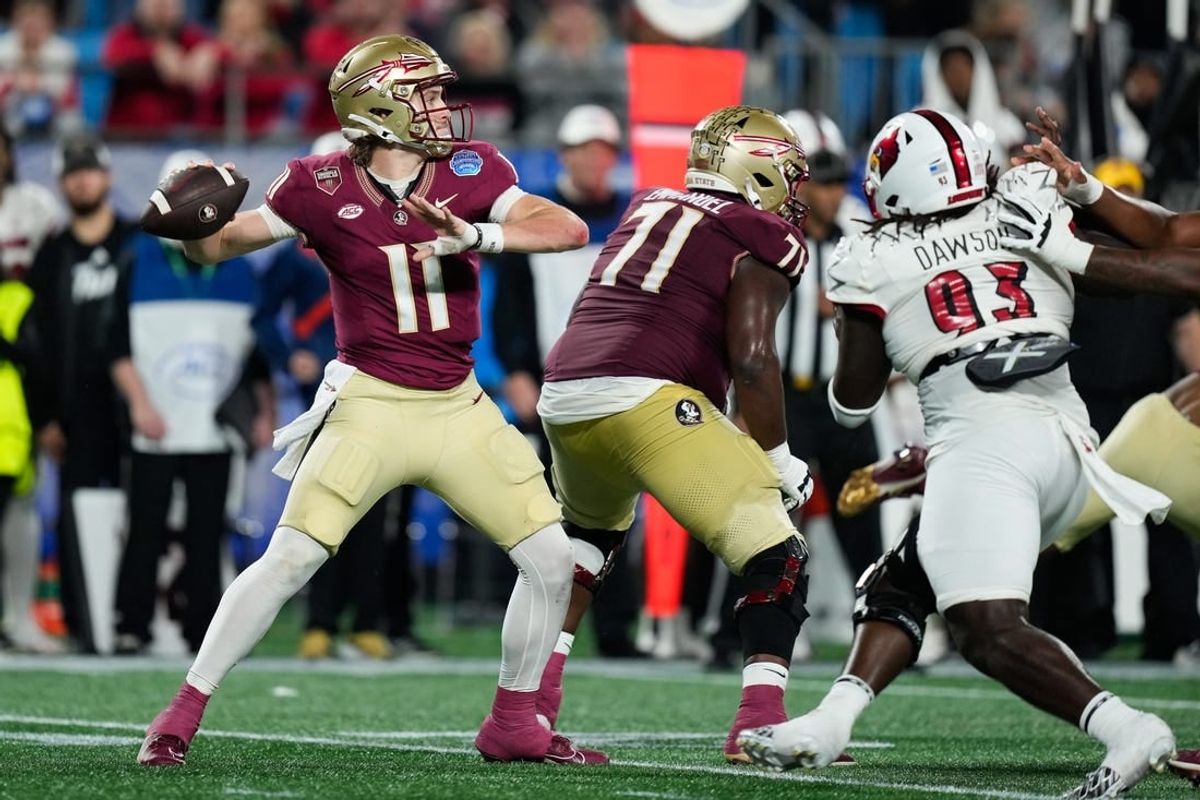 Dec 2, 2023; Charlotte, NC, USA; Florida State Seminoles quarterback Brock Glenn (11) throws against the Louisville Cardinals during the second quarter at Bank of America Stadium.