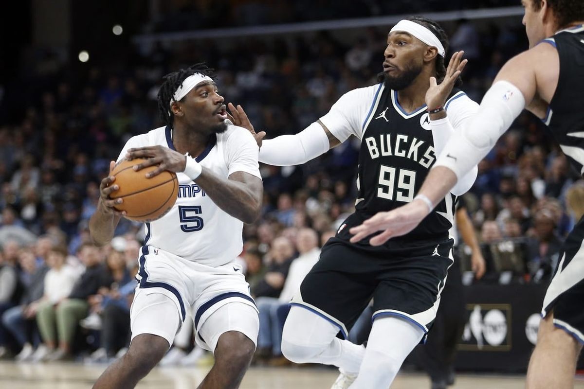 Feb 15, 2024; Memphis, Tennessee, USA; Memphis Grizzlies guard Vince Williams Jr. (5) handles the ball as Milwaukee Bucks forward Jae Crowder (99) defends during the first half at FedExForum.