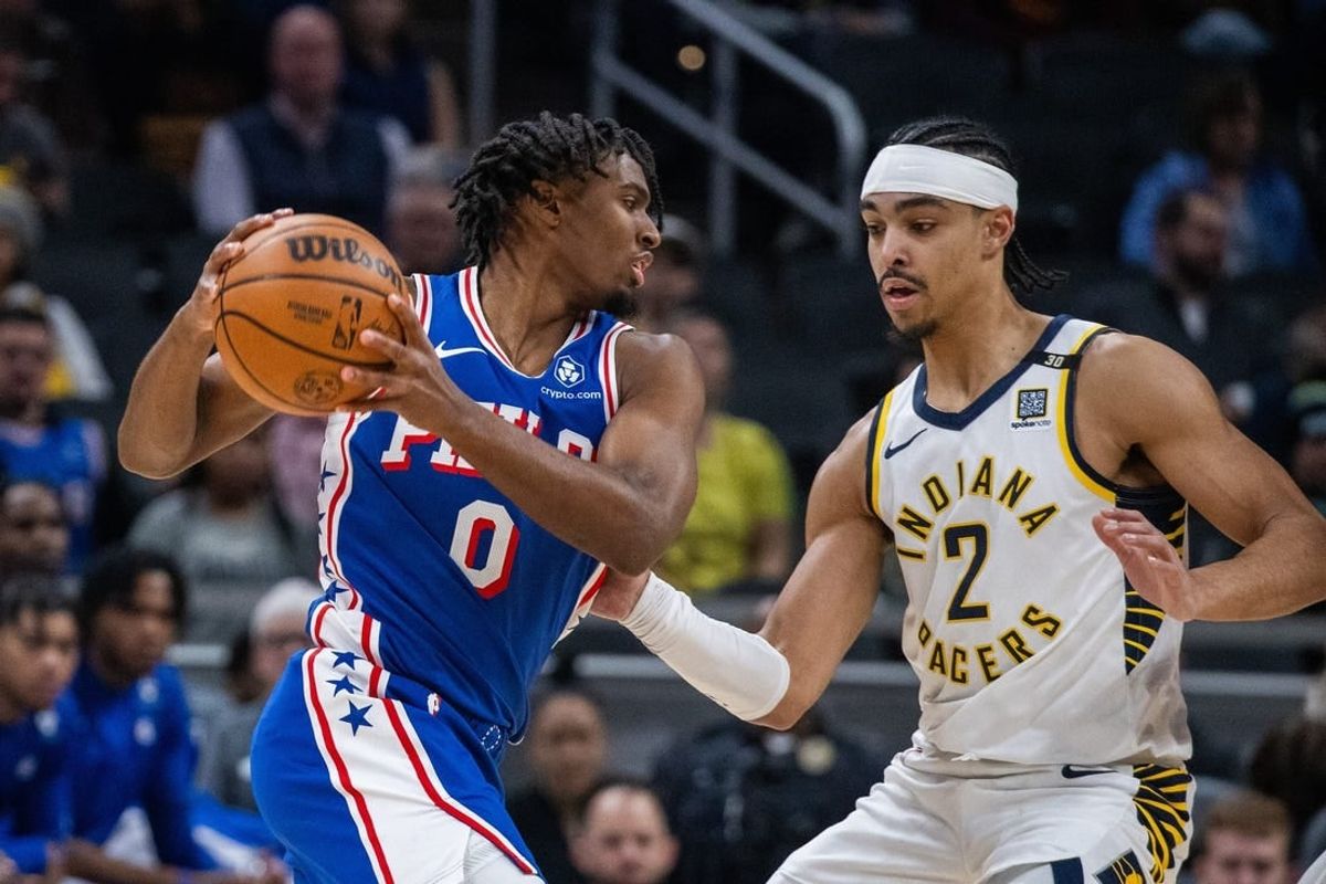 Jan 25, 2024; Indianapolis, Indiana, USA; Philadelphia 76ers guard Tyrese Maxey (0) drives to the basket while Indiana Pacers guard Andrew Nembhard (2) defends in the first half at Gainbridge Fieldhouse.