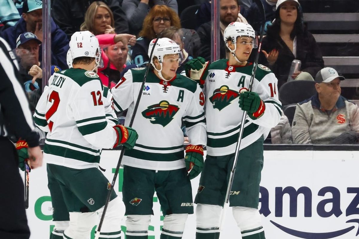 Feb 24, 2024; Seattle, Washington, USA; Minnesota Wild left wing Kirill Kaprizov (97) celebrates with center Joel Eriksson Ek (14) after scoring a goal against the Seattle Kraken during the first period at Climate Pledge Arena.