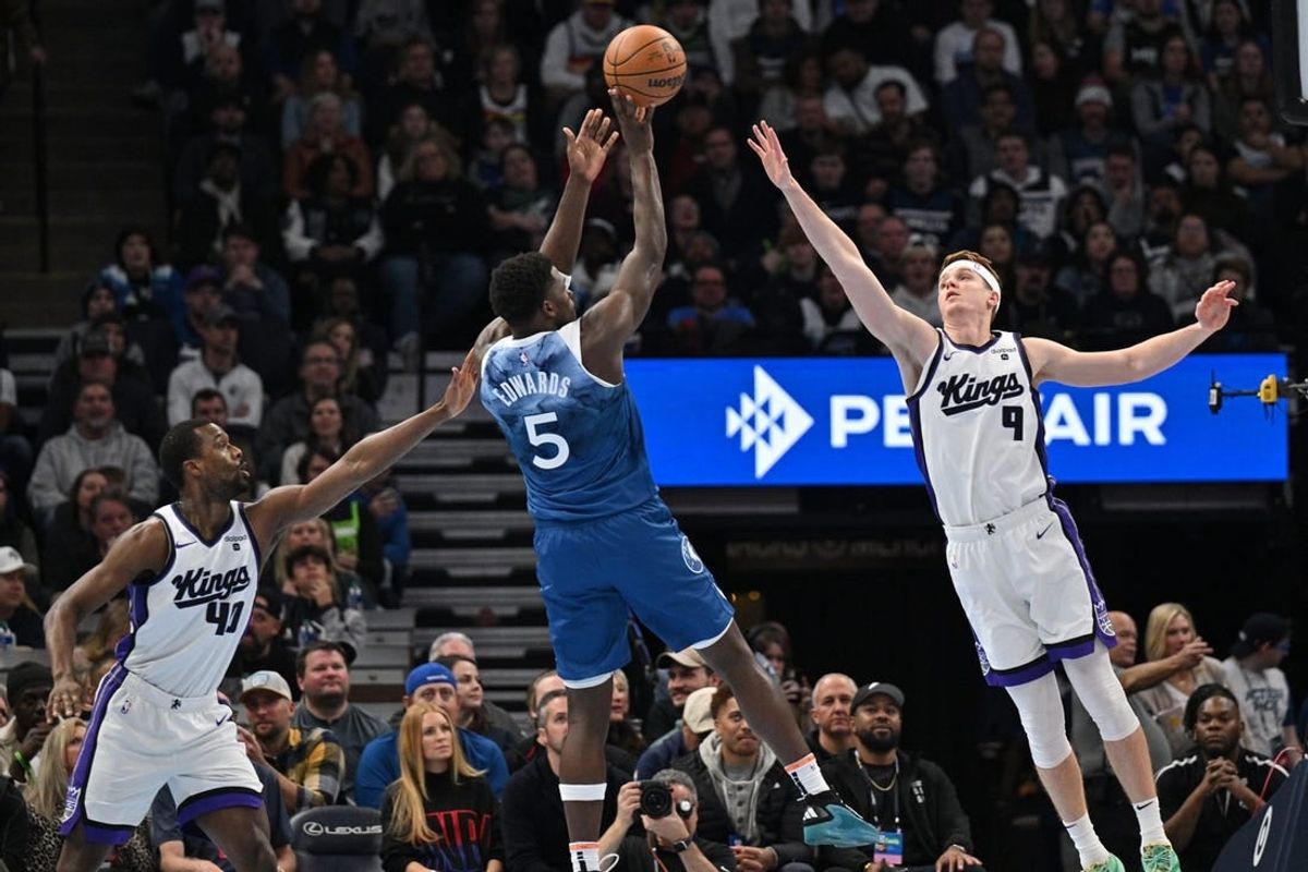 Nov 24, 2023; Minneapolis, Minnesota, USA; Sacramento Kings forward Harrison Barnes (40) and guard Kevin Huerter (9) defend the shot of Minnesota Timberwolves guard Anthony Edwards (5) during the first quarter at Target Center.