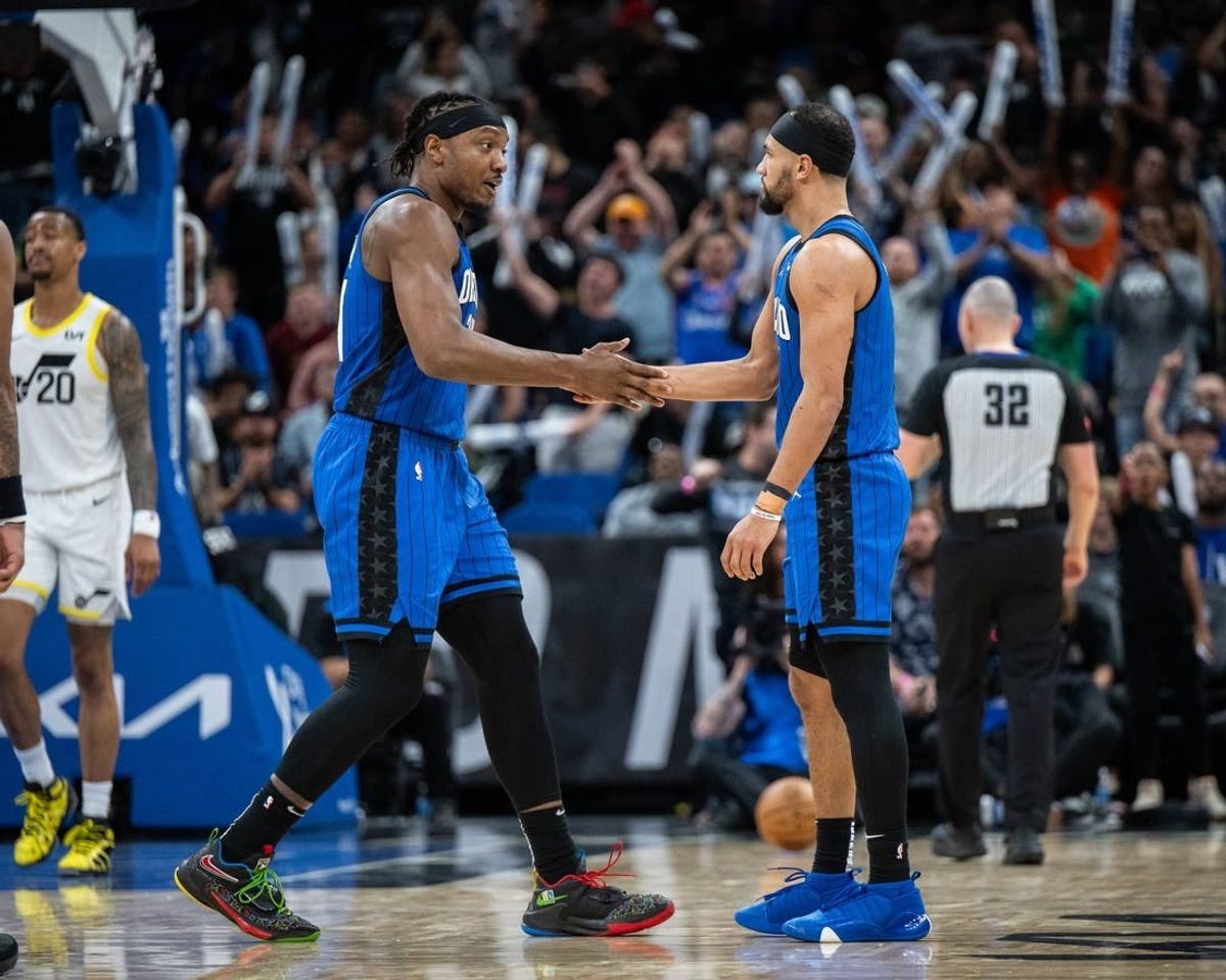 Feb 29, 2024; Orlando, Florida, USA; Orlando Magic center Wendell Carter Jr. (34) and guard Jalen Suggs (4) celebrate a three pointer against the Utah Jazz in the fourth quarter at Kia Center.