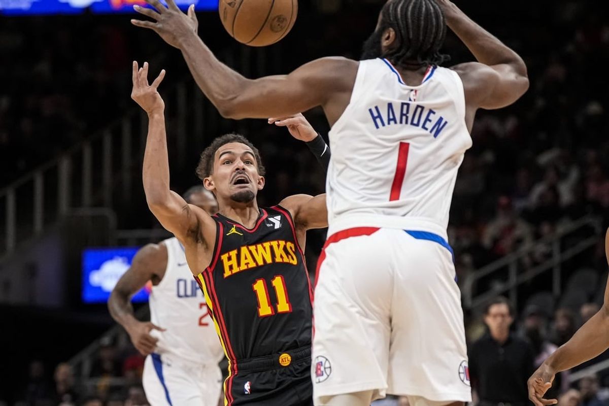 Feb 5, 2024; Atlanta, Georgia, USA; Atlanta Hawks guard Trae Young (11) looses the ball against LA Clippers guard James Harden (1) during the first half at State Farm Arena.