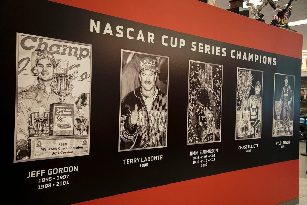 Images of past NASCAR Cup Series champions are on display in the museum on the Hendrick Motorsports campus in Concord, North Carolina. Hendrick Motorsports' Cup Series holds titles with five different drivers: Jimmie Johnson (seven), Jeff Gordon (four), Terry Labonte (1996), Chase Elliott (2020) and Larson (2021), according to NASCAR.
