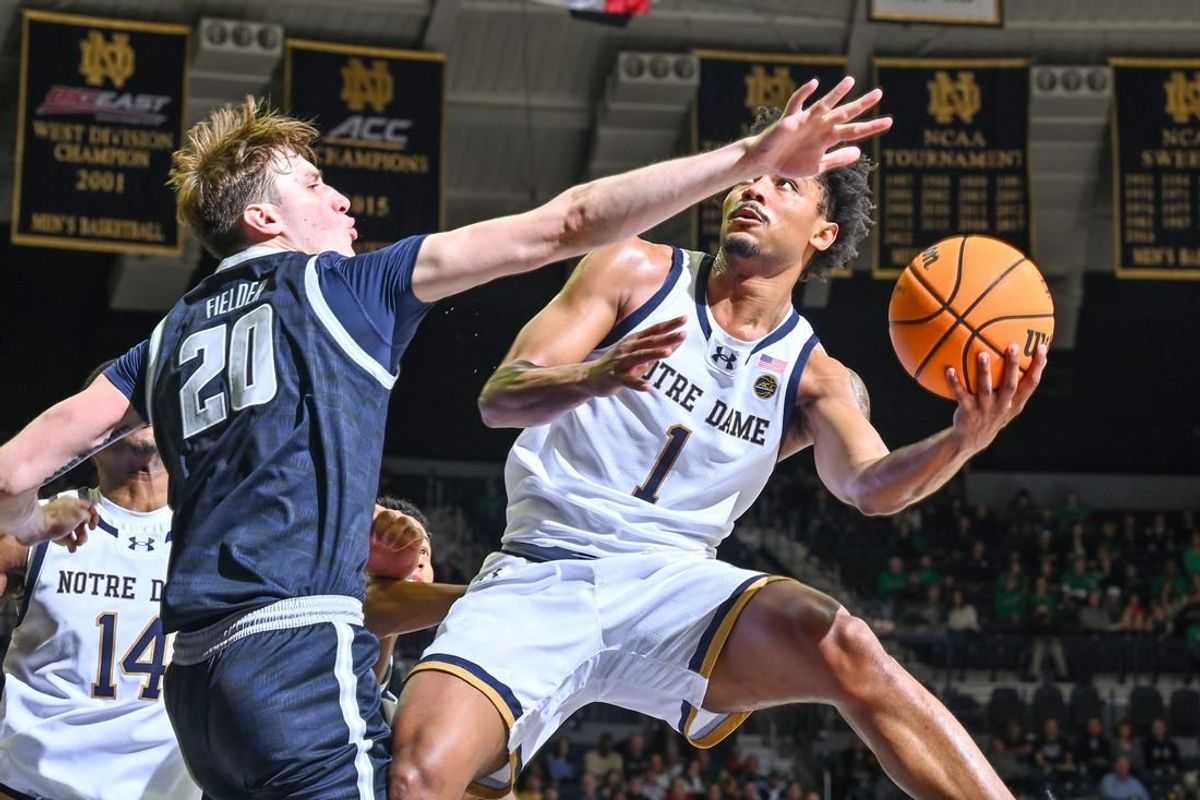 Dec 16, 2023; South Bend, Indiana, USA; Notre Dame Fighting Irish guard Julian Roper II (1) goes up for a shot as Georgetown Hoyas forward Drew Fielder (20) defends in the first half at the Purcell Pavilion.