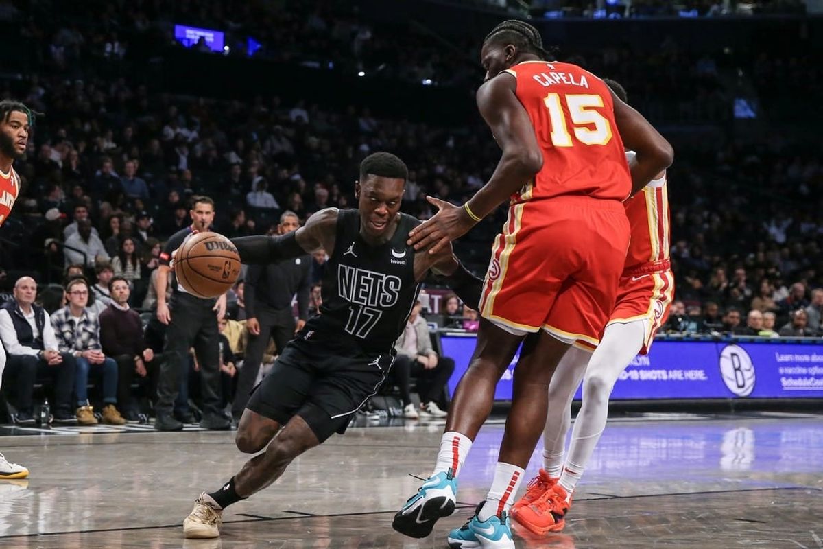 Feb 29, 2024; Brooklyn, New York, USA;  Brooklyn Nets guard Dennis Schroder (17) moves the ball against Atlanta Hawks center Clint Capela (15) in the first quarter at Barclays Center.