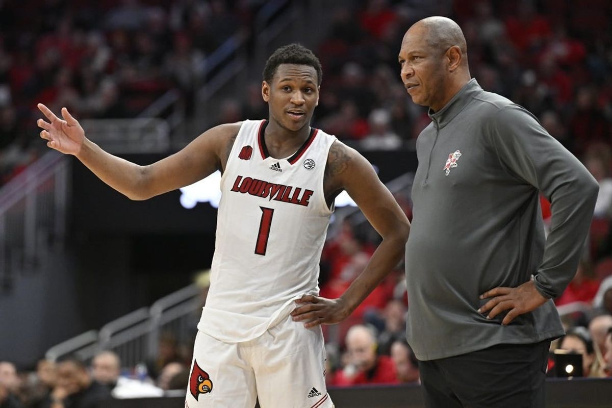 Jan 13, 2024; Louisville, Kentucky, USA;  Louisville Cardinals guard Curtis Williams (1) talks with head coach Kenny Payne during the second half against the North Carolina State Wolfpack at KFC Yum! Center.