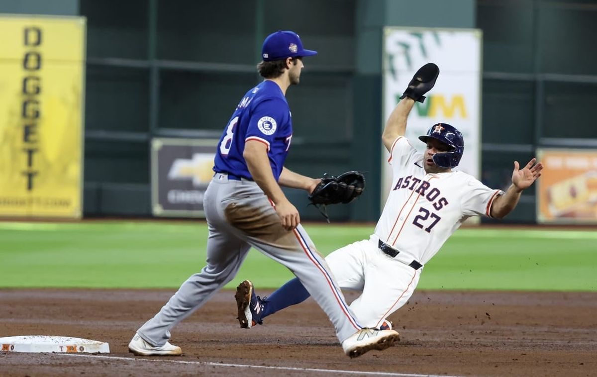 Apr 13, 2024; Houston, Texas, USA;  Houston Astros second base Jose Altuve (27) tags up against Texas Rangers third baseman Josh Smith (8) in the fourth inning at Minute Maid Park.