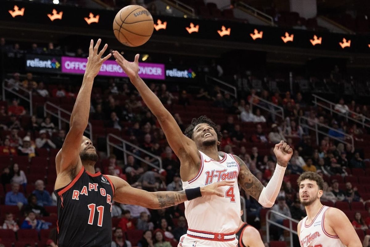 Feb 2, 2024; Houston, Texas, USA; Toronto Raptors forward Bruce Brown (11) and Houston Rockets guard Jalen Green (4) reach for a rebound in the first quarter at Toyota Center.