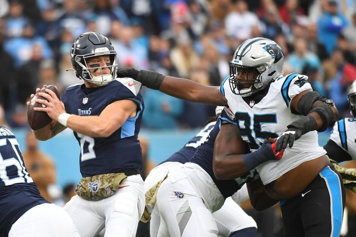 Nov 26, 2023; Nashville, Tennessee, USA; Tennessee Titans quarterback Will Levis (8) stands in the pocket as he is pressured by Carolina Panthers defensive tackle Derrick Brown (95) during the first half at Nissan Stadium.