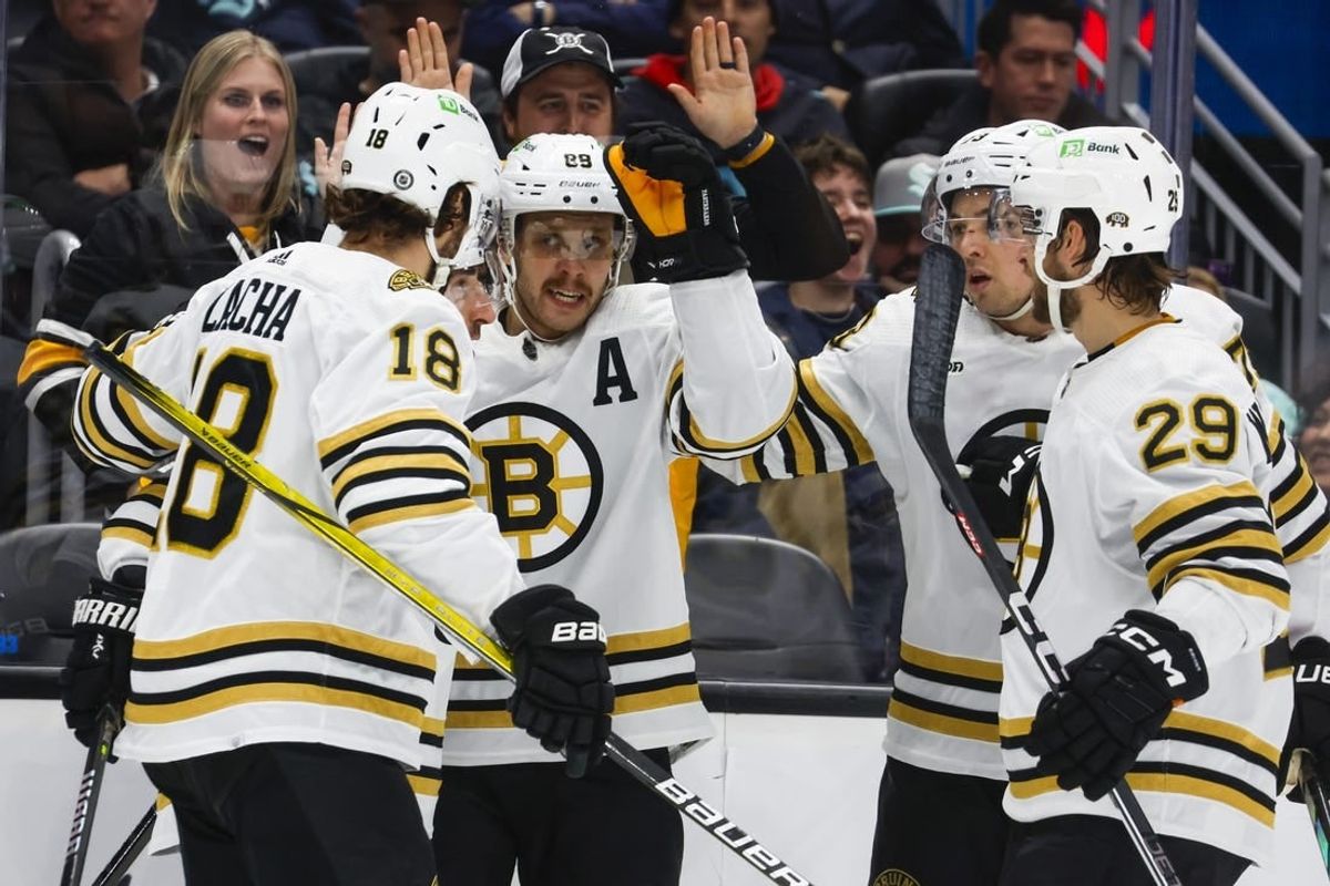 Feb 26, 2024; Seattle, Washington, USA; Boston Bruins right wing David Pastrnak (88, middle) celebrates with teammates   after scoring a goal against the Seattle Kraken during the second period at Climate Pledge Arena.