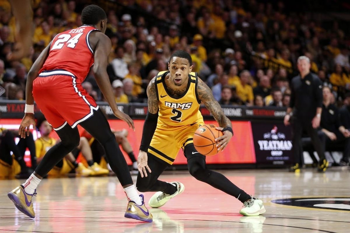Feb 9, 2024; Richmond, Virginia, USA; Virginia Commonwealth Rams guard Zeb Jackson (2) dribbles the ball as Dayton Flyers guard Kobe Elvis (24) defends during the first half at Stuart C. Siegel Center.