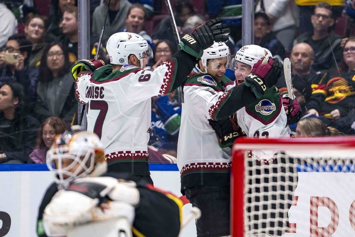 Apr 10, 2024; Vancouver, British Columbia, CAN; Arizona Coyotes forward Lawson Crouse (67) and forward Dylan Guenther (11) and forward Logan Cooley (92) celebrate Cooley’s game winning overtime goal against the Vancouver Canucks at Rogers Arena. Arizona won 4-3 in overtime.