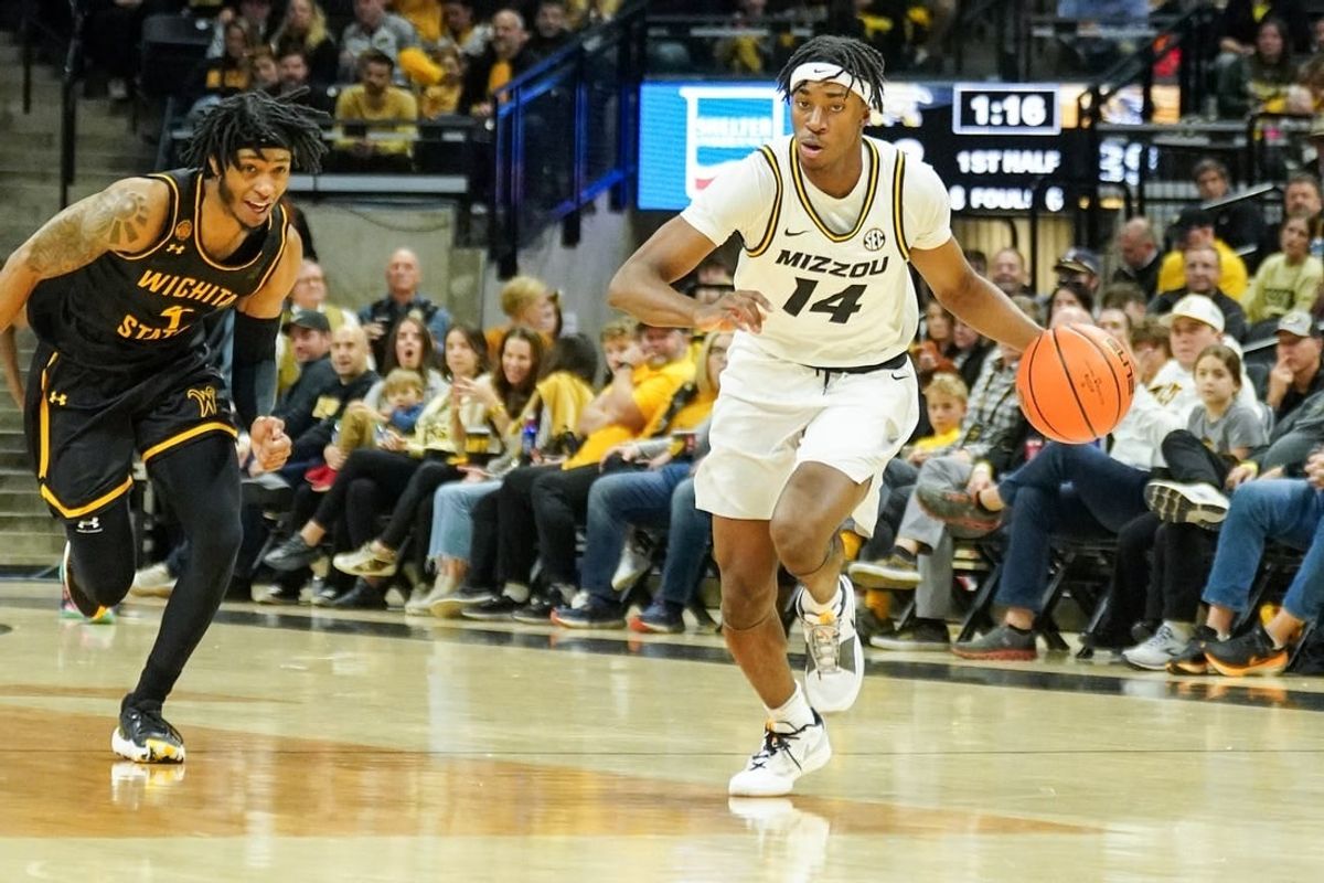Dec 3, 2023; Columbia, Missouri, USA; Missouri Tigers guard Anthony Robinson II (14) steals the ball and dribbles as Wichita State Shockers guard Colby Rogers (4) defends during the first half at Mizzou Arena.