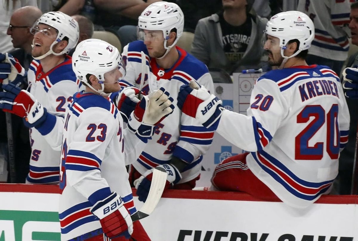 Mar 16, 2024; Pittsburgh, Pennsylvania, USA;  New York Rangers defenseman Adam Fox (23) celebrates his goal with the Rangers bench against the Pittsburgh Penguins during the first period at PPG Paints Arena.