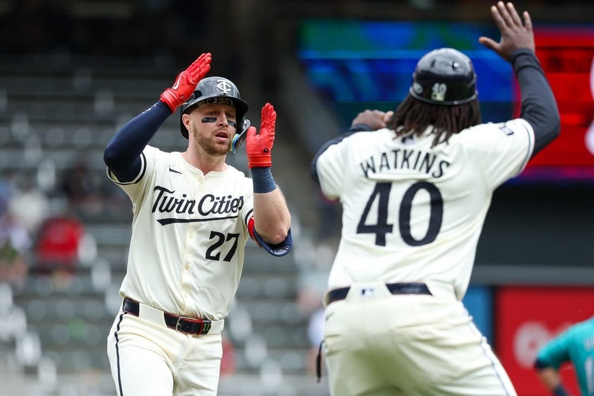 May 9, 2024; Minneapolis, Minnesota, USA; Minnesota Twins Ryan Jeffers (27) celebrates his solo home run with third base coach Tommy Watkins (40) during the second inning against the Seattle Mariners at Target Field.