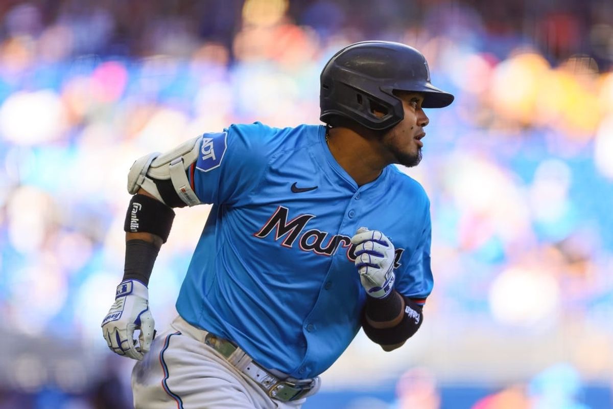 Apr 14, 2024; Miami, Florida, USA; Miami Marlins second baseman Luis Arraez (3) hits a single against the Atlanta Braves during the seventh inning at loanDepot Park.