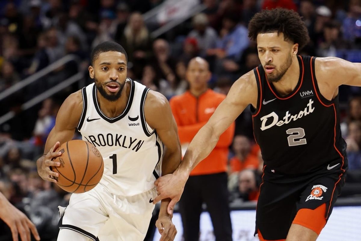Dec 26, 2023; Detroit, Michigan, USA; Brooklyn Nets forward Mikal Bridges (1) dribbles while defended by Detroit Pistons guard Cade Cunningham (2) in the second half at Little Caesars Arena.