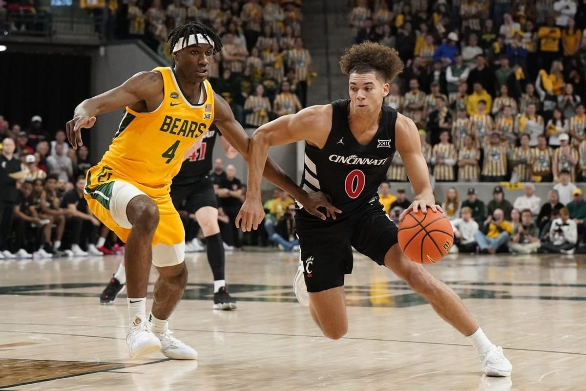 Jan 13, 2024; Waco, Texas, USA; Cincinnati Bearcats guard Dan Skillings Jr. (0) works around Baylor Bears guard Ja'Kobe Walter (4) during the first half at Paul and Alejandra Foster Pavilion.