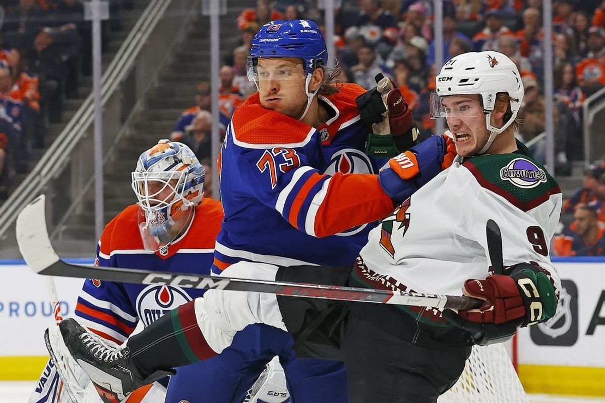 Apr 12, 2024; Edmonton, Alberta, CAN; Edmonton Oilers defensemen Vincent Desharnais (73) and Arizona Coyotes forward Josh Doan (91) battles for position  during the second period at Rogers Place.