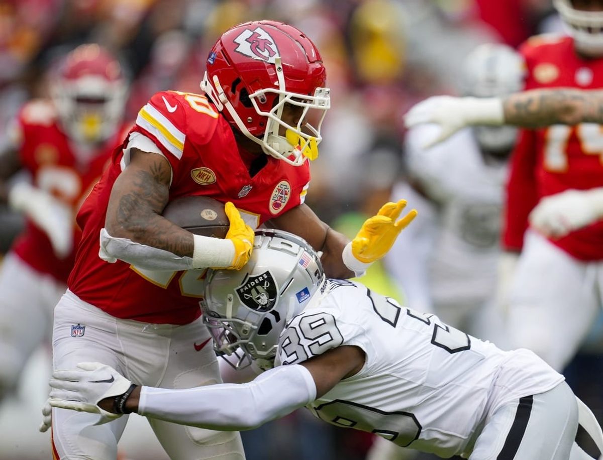 Dec 25, 2023; Kansas City, Missouri, USA; Kansas City Chiefs running back Isiah Pacheco (10) runs the ball against Las Vegas Raiders cornerback Nate Hobbs (39) during the first half at GEHA Field at Arrowhead Stadium.