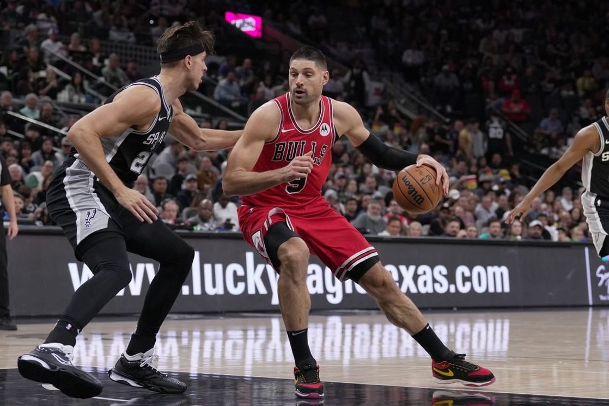 Dec 8, 2023; San Antonio, Texas, USA;  Chicago Bulls center Nikola Vucevic (9) moves against San Antonio Spurs forward Zach Collins (23) in the first half at the Frost Bank Center.