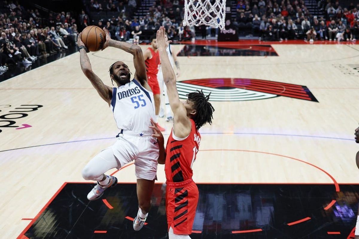 Dec 8, 2023; Portland, Oregon, USA; Dallas Mavericks small forward Derrick Jones Jr. (55) shoots the ball against Portland Trail Blazers shooting guard Shaedon Sharpe (17, right) during the first half at Moda Center.